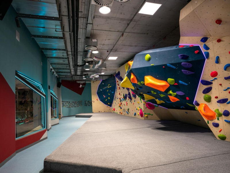Gravity Boulder Budapest - Walltopia boulder walls with natural wood panels and LED lights