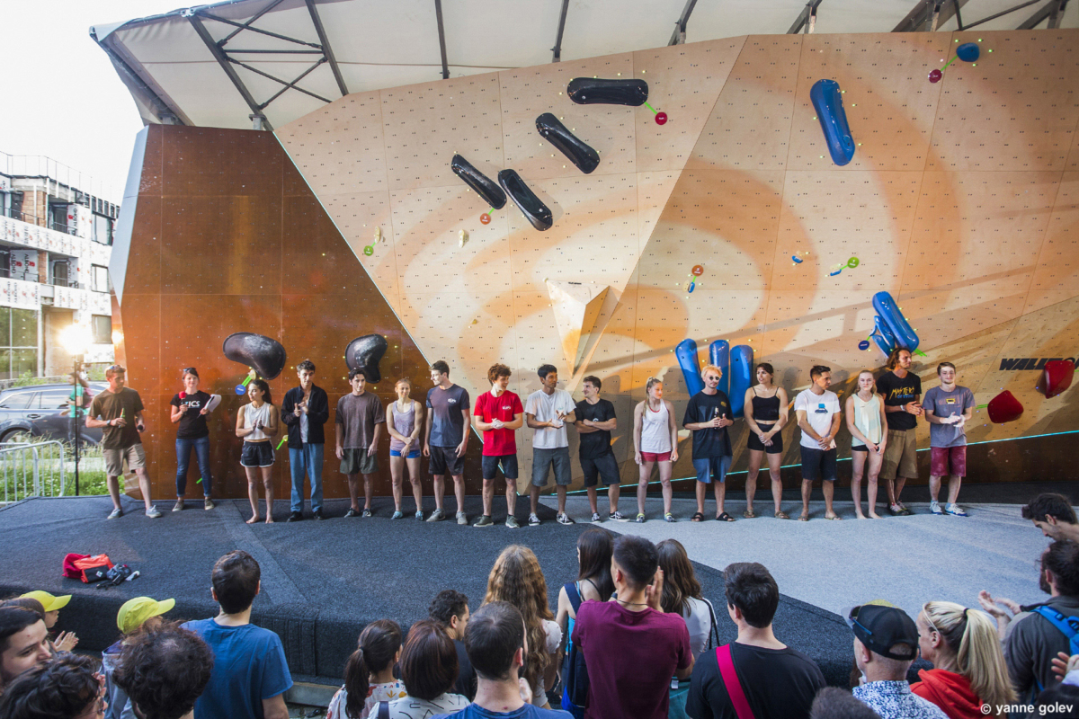 Climbers and routesetters in front of the natural wood boulder during Set & Send Boulder Comp in Sofia, Bulgaria