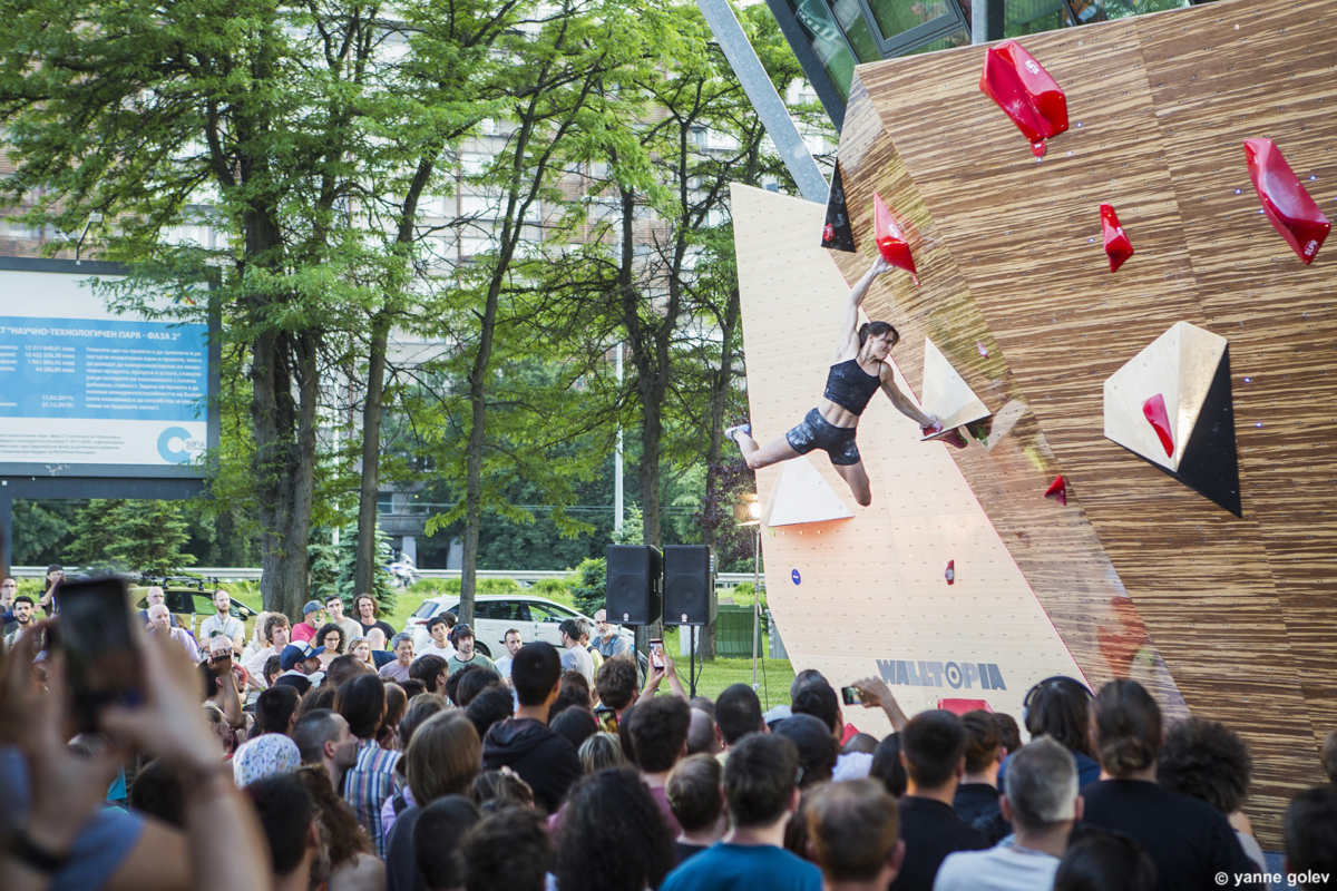 Female climber Cloe Coscoy competing on the bamboo boulder during Set & Send Boulder Comp in Sofia, Bulgaria