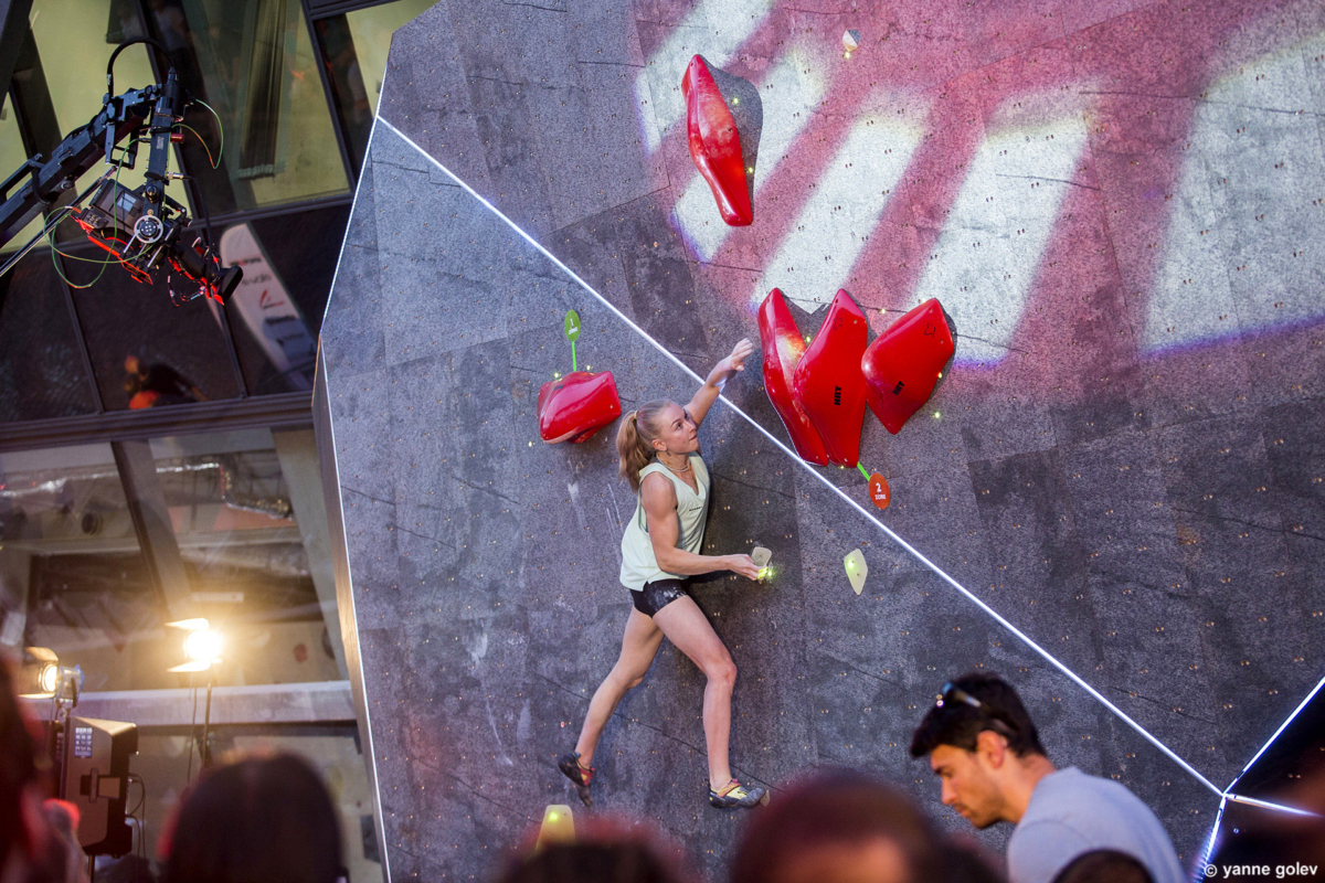 Female climber Lucia Dorfell competing on the natural stone boulder during Set & Send Boulder Comp in Sofia, Bulgaria